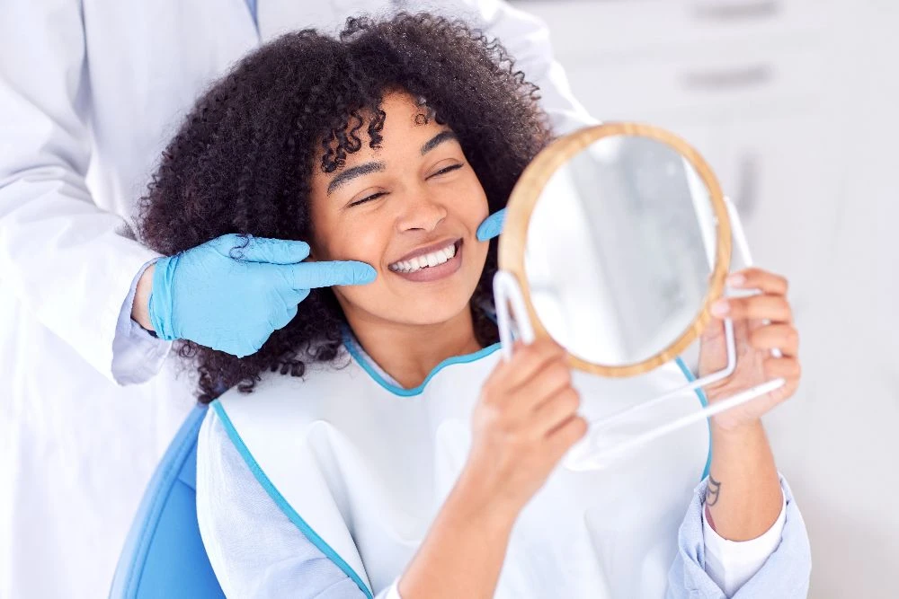 Patient seeing her smile with a mirror